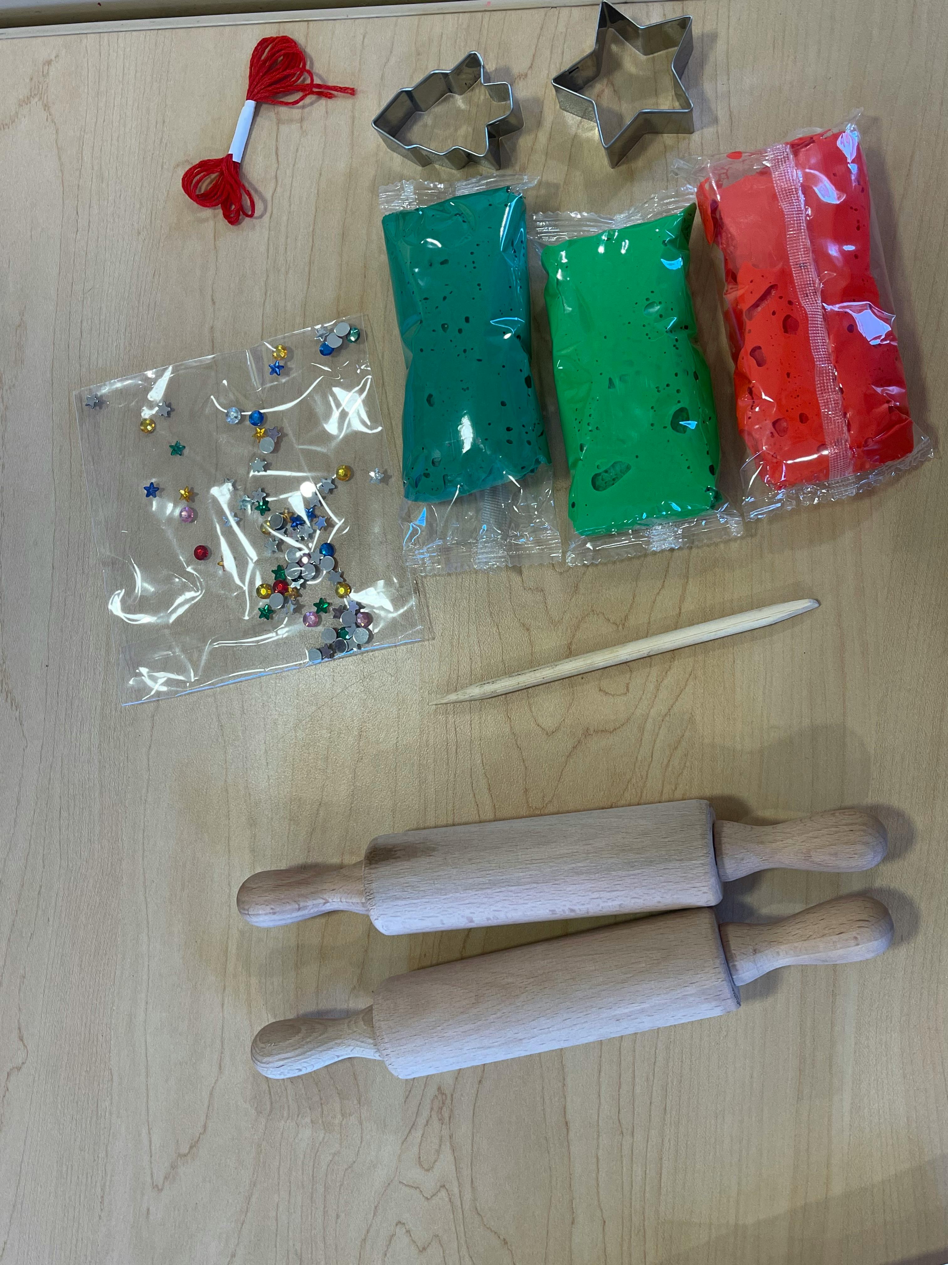 Craft supplies including playdough, cookie cutters, beads, and rolling pins