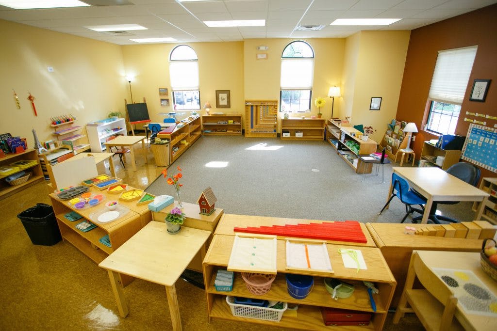 Classroom with tables, shelves, and learning materials