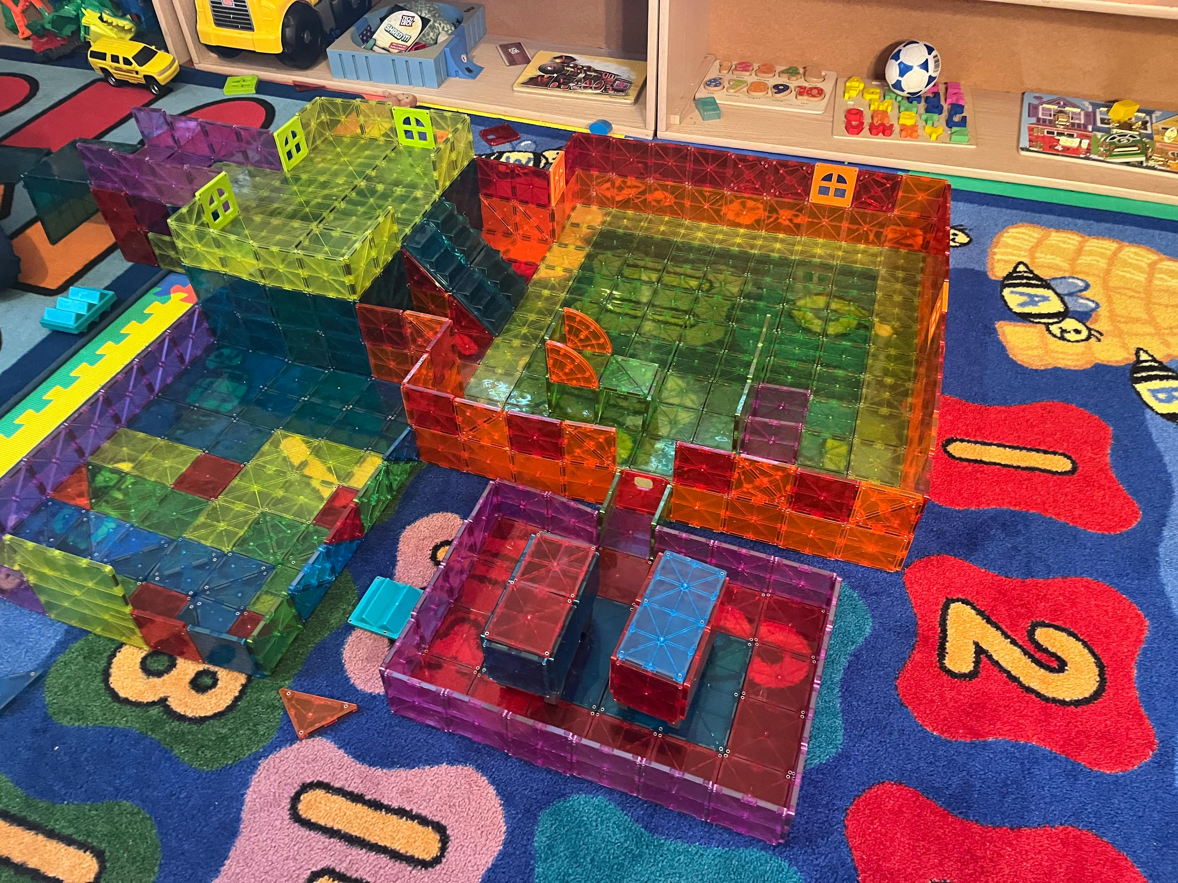 Colorful magnetic tile structures on a patterned rug