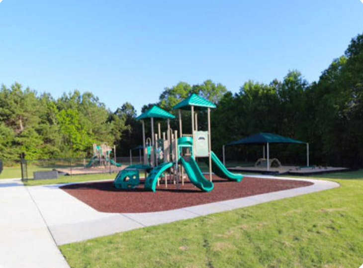 Playground with green slides and climbing structures