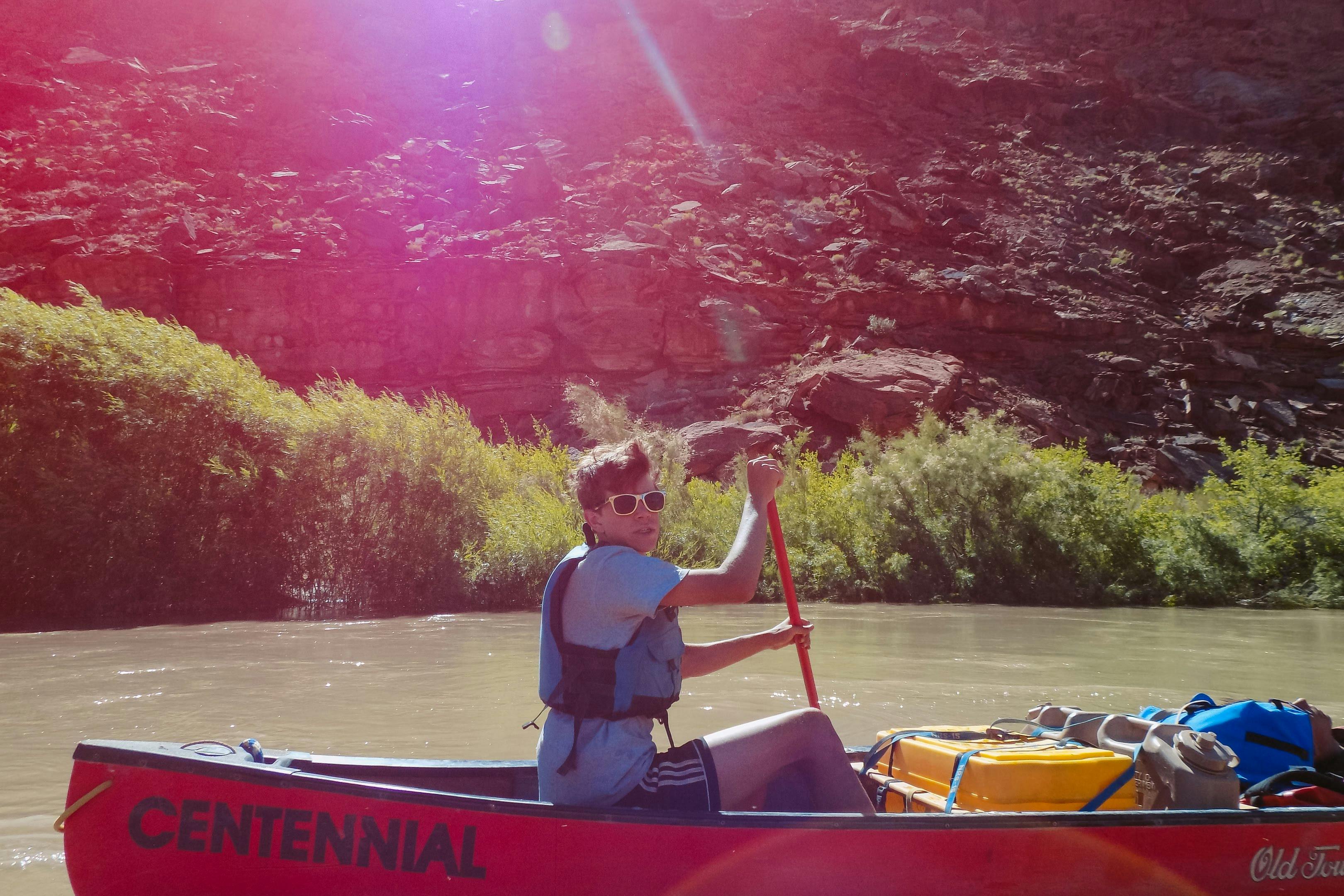 Person in a canoe paddling on a river