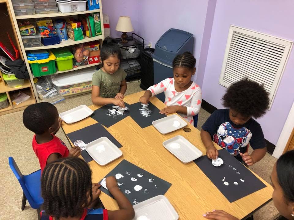 Children doing an art activity at a table