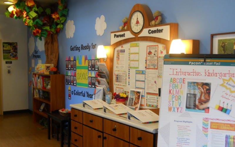 Parent Center sign over a bulletin board with school information and a bookshelf