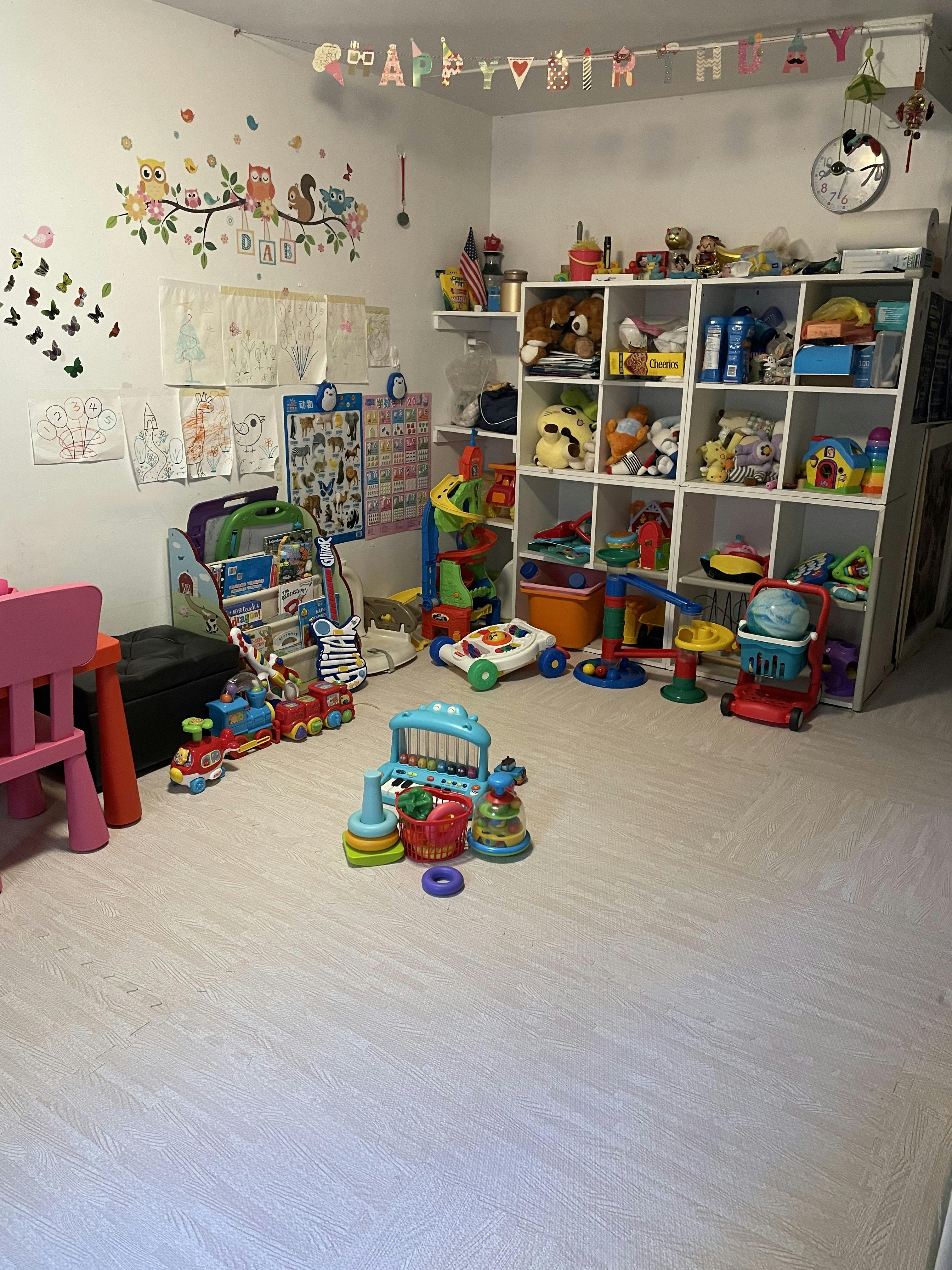 Children's playroom with toys on the floor and shelves
