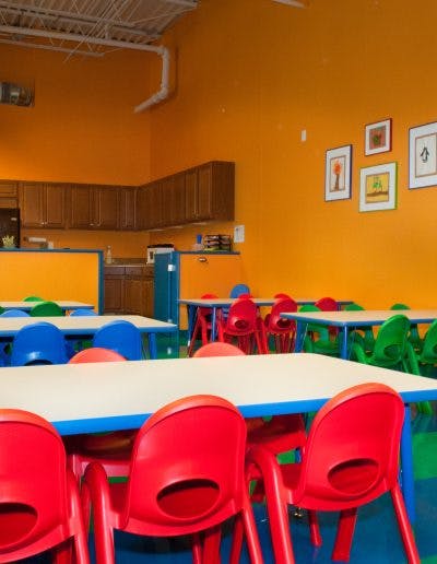 Classroom with small tables and colorful chairs