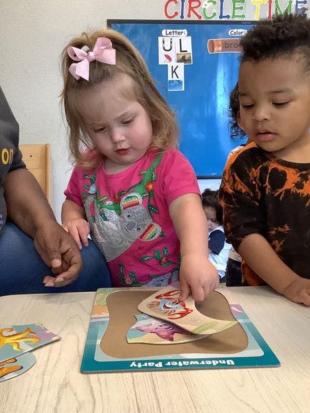 Child playing with a puzzle in a classroom