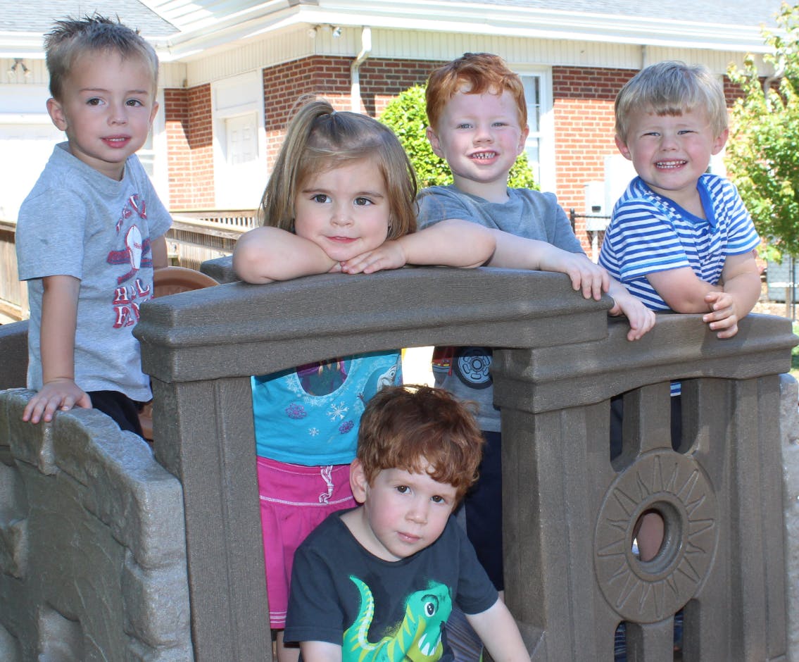 Five children on a playground structure