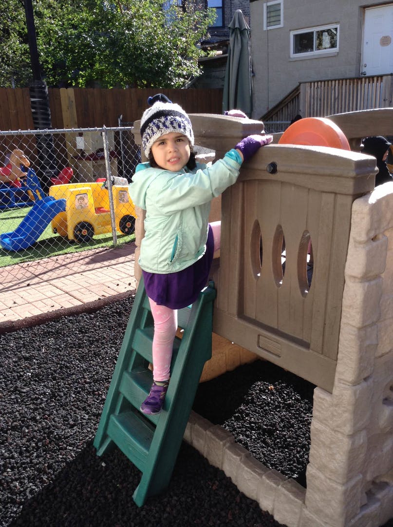 Child climbing a ladder on a playground structure