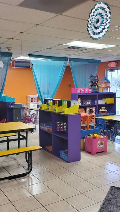 Classroom with tables, shelves, and colorful decorations