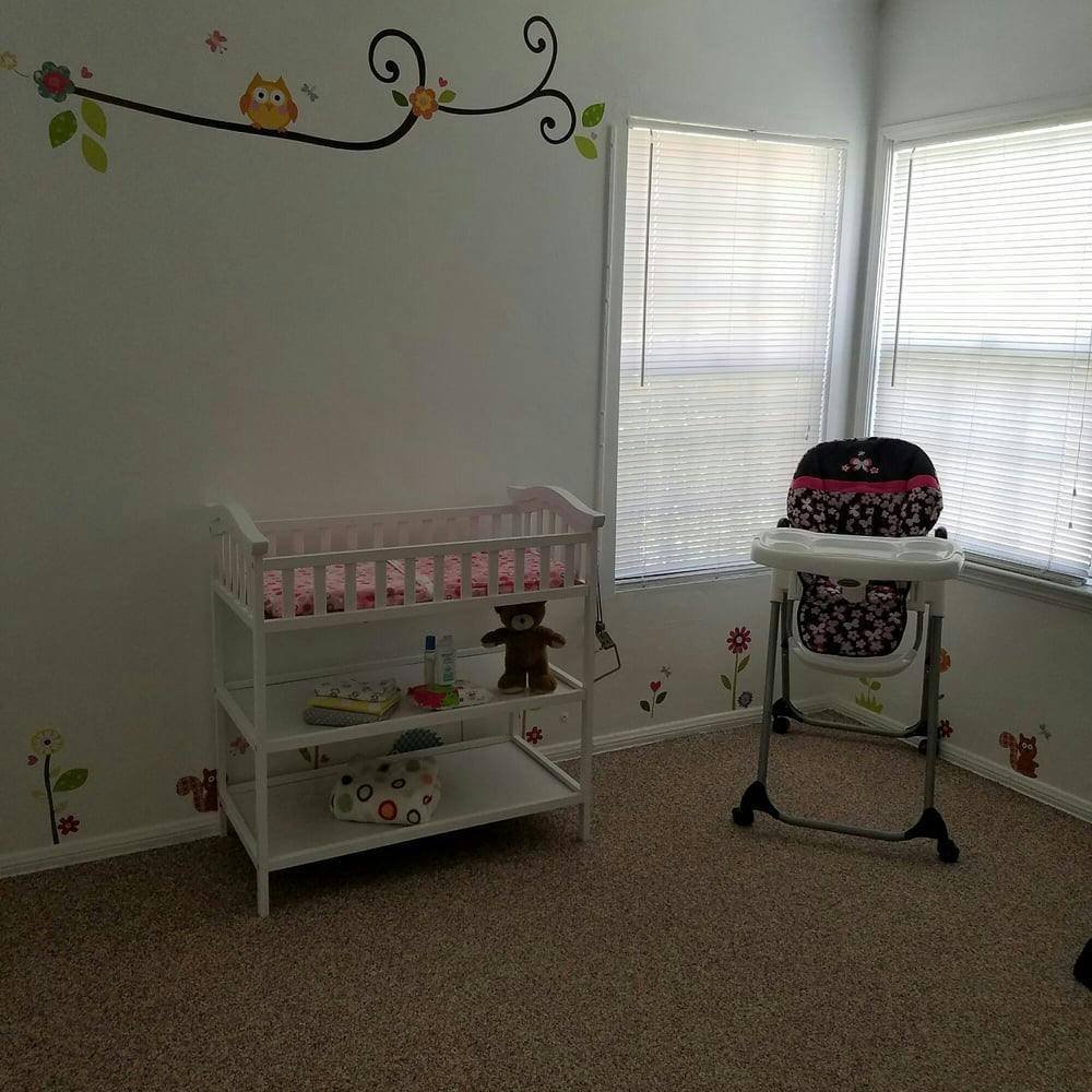 Nursery room with a changing table and a high chair