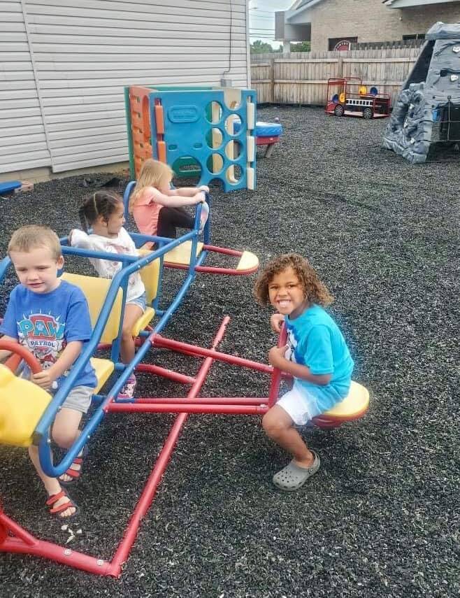 Children playing on a seesaw in a playground