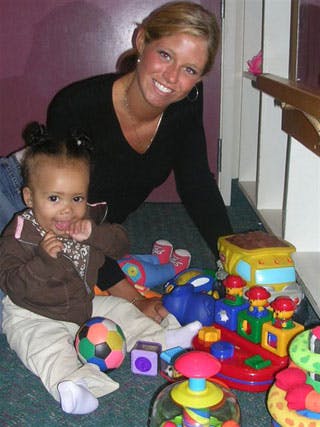 Person and child on floor with toys