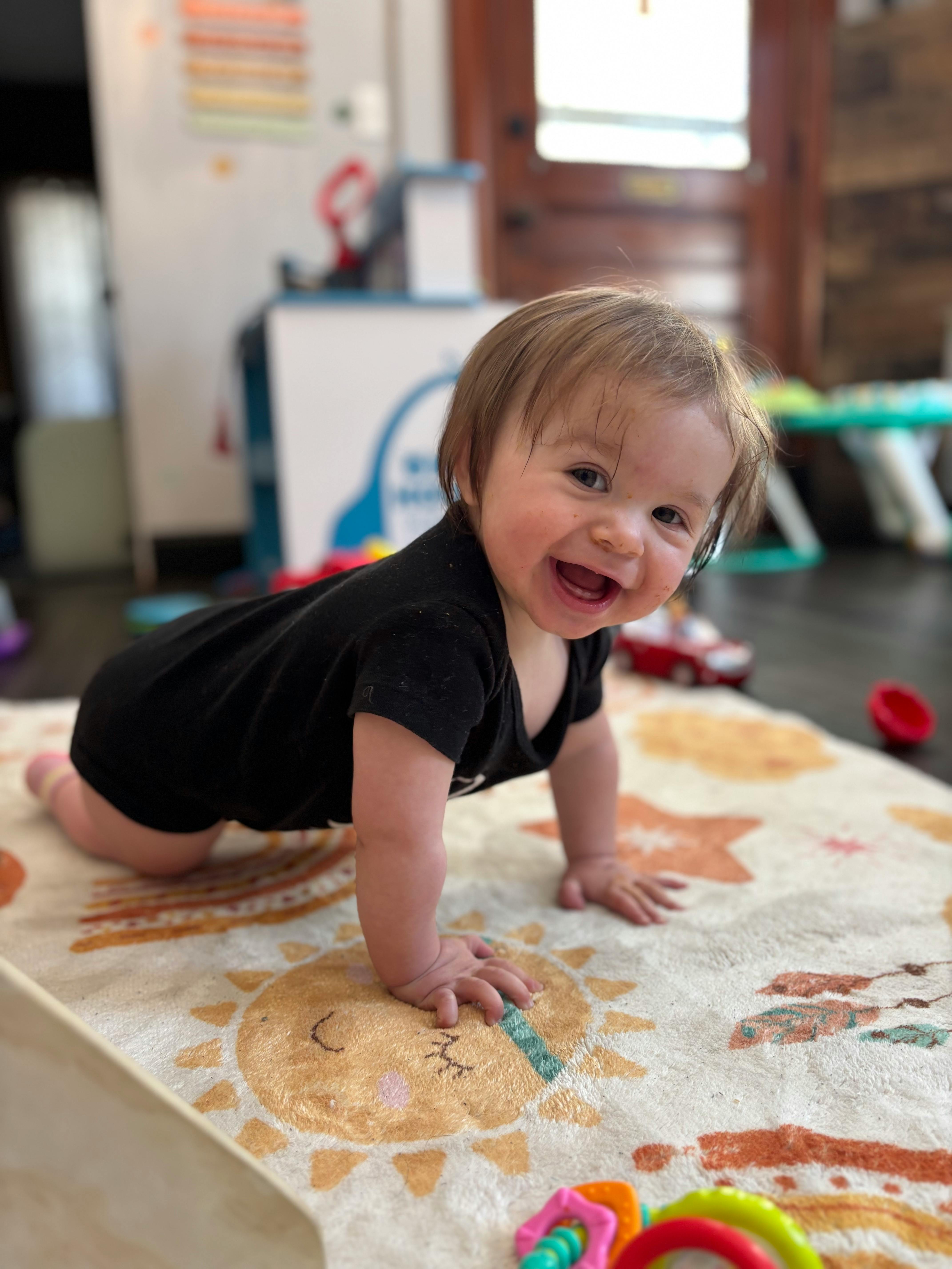 Child crawling on a rug
