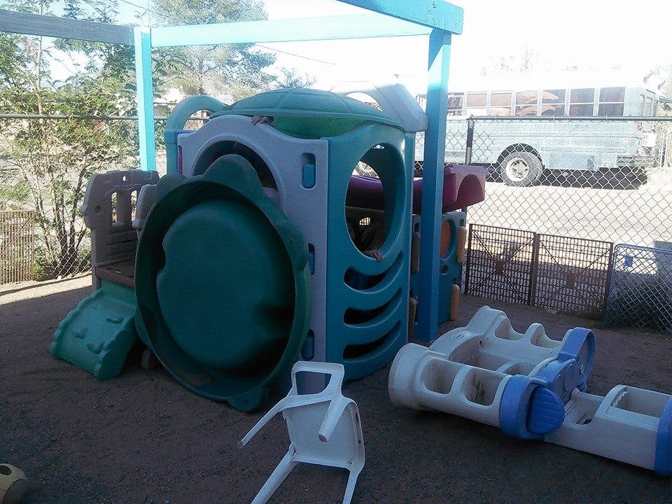 Playground equipment with a slide and climbing structure