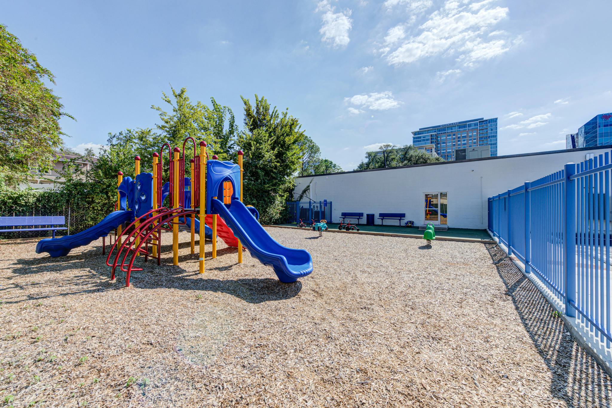 Colorful playground with slides, climbers, and wood chips