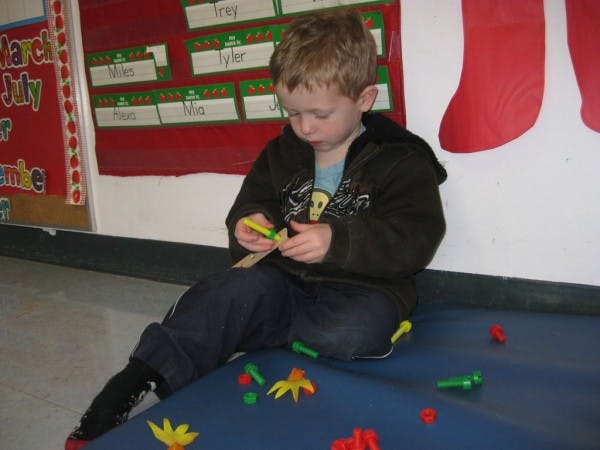 Child playing with colorful plastic shapes