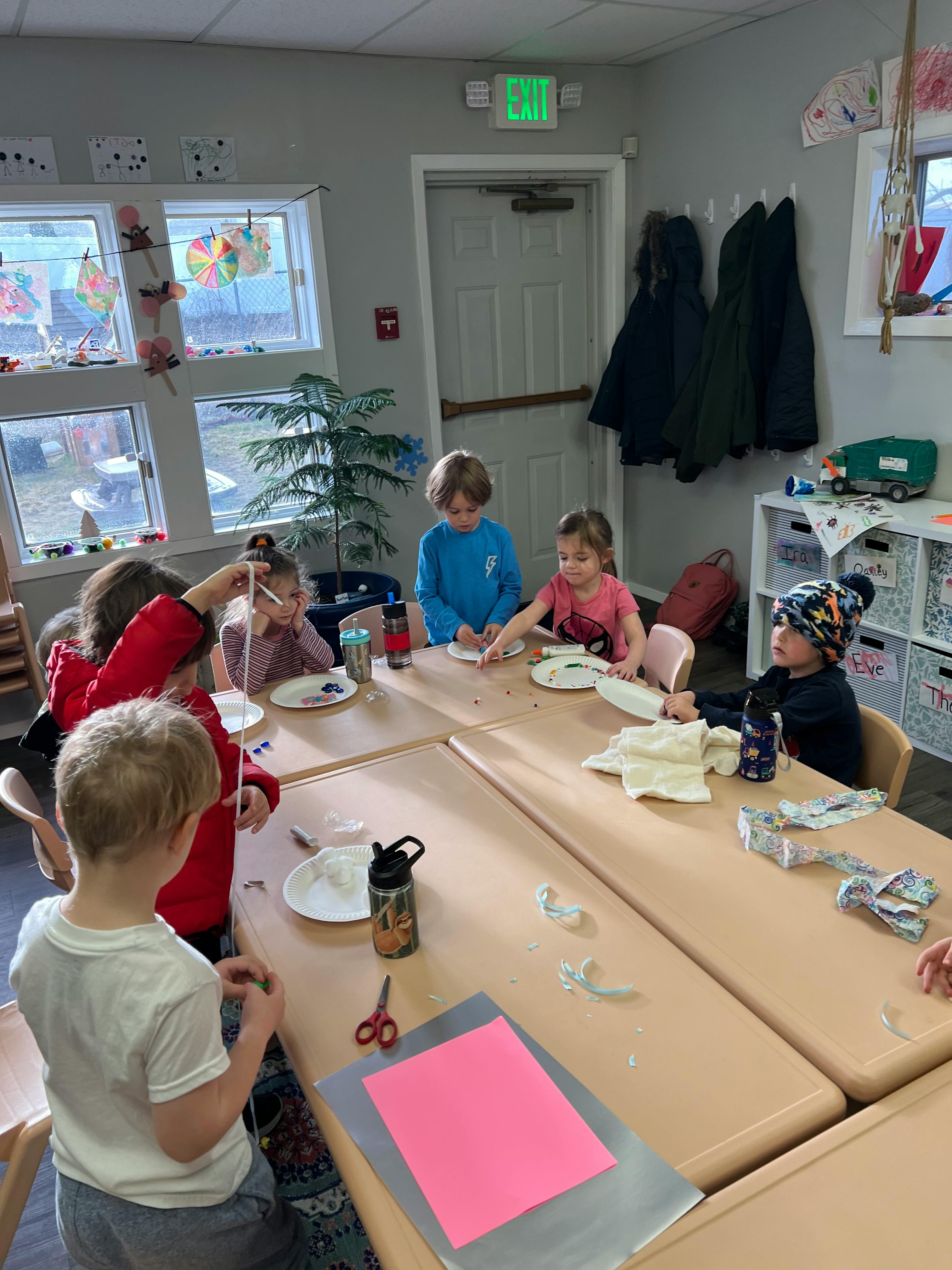 Children sitting at tables in a classroom