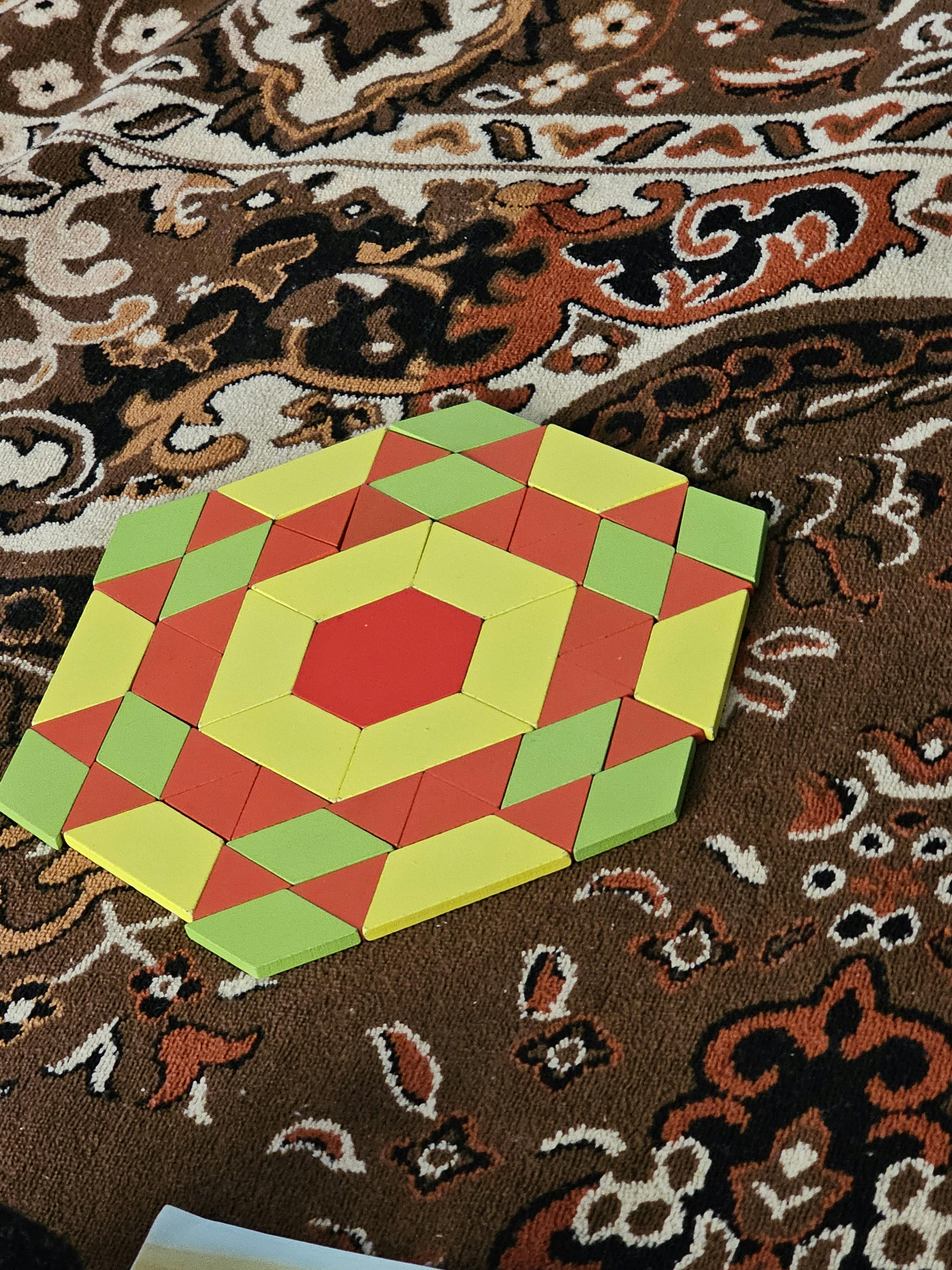 Hexagonal pattern made of red, yellow, and green geometric shapes
