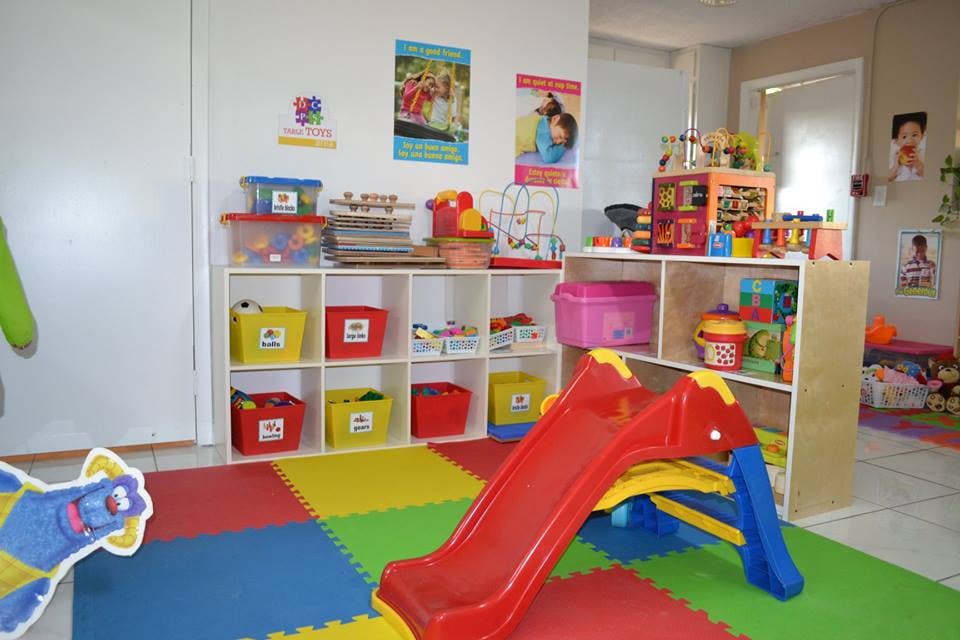 Playroom with a small slide and shelves