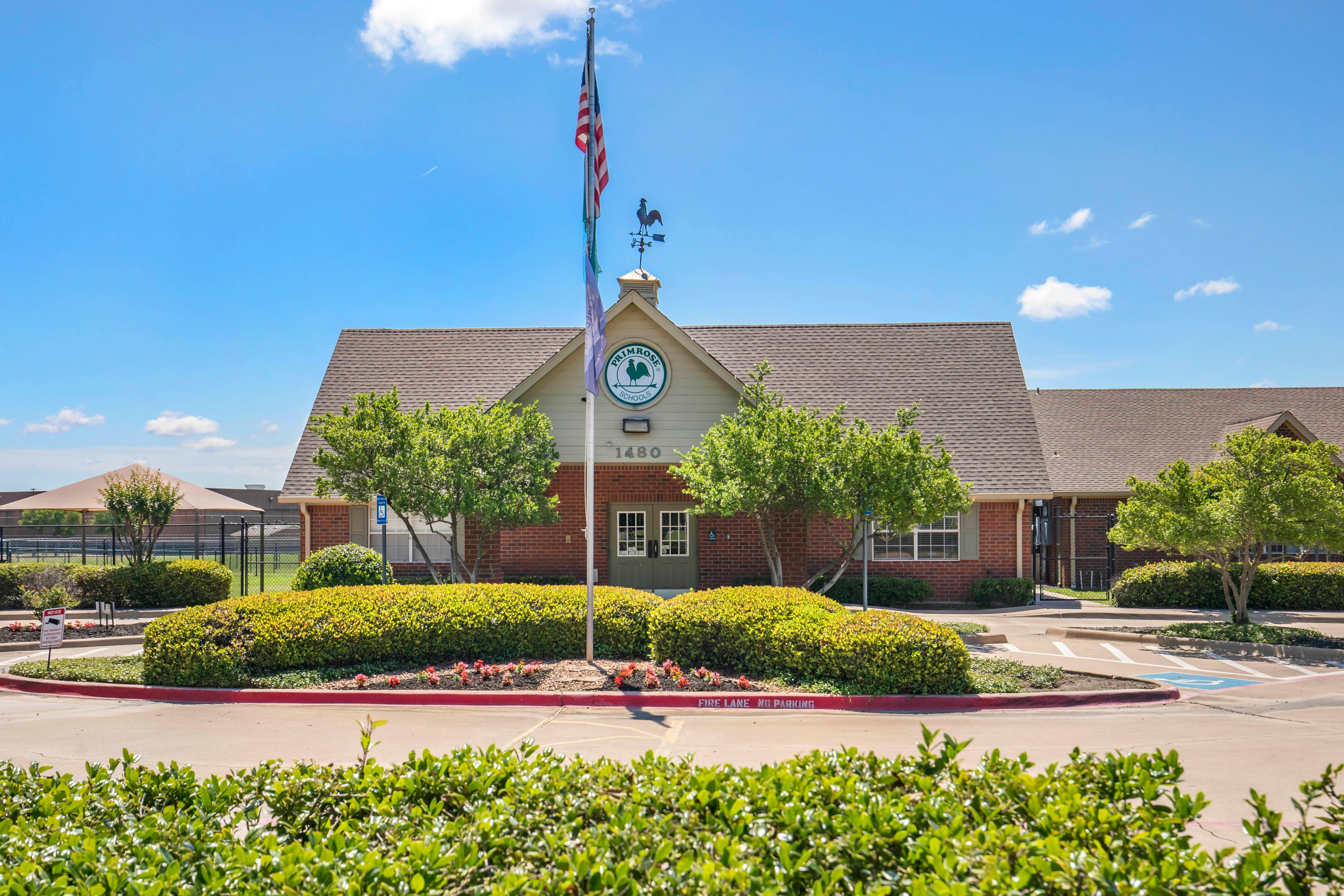 Primrose school building with a flag pole and circular drive