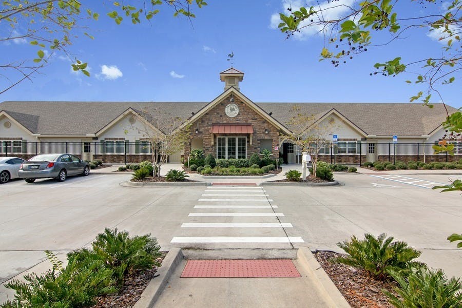 Building with a clock tower and a crosswalk leading to the entrance