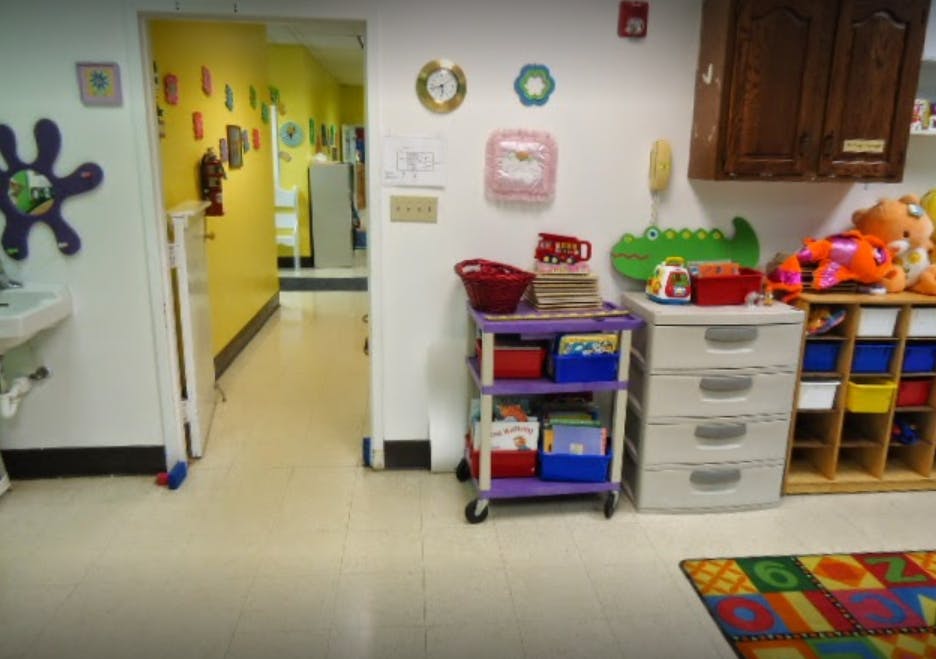 Children's play area with storage units and a colorful rug