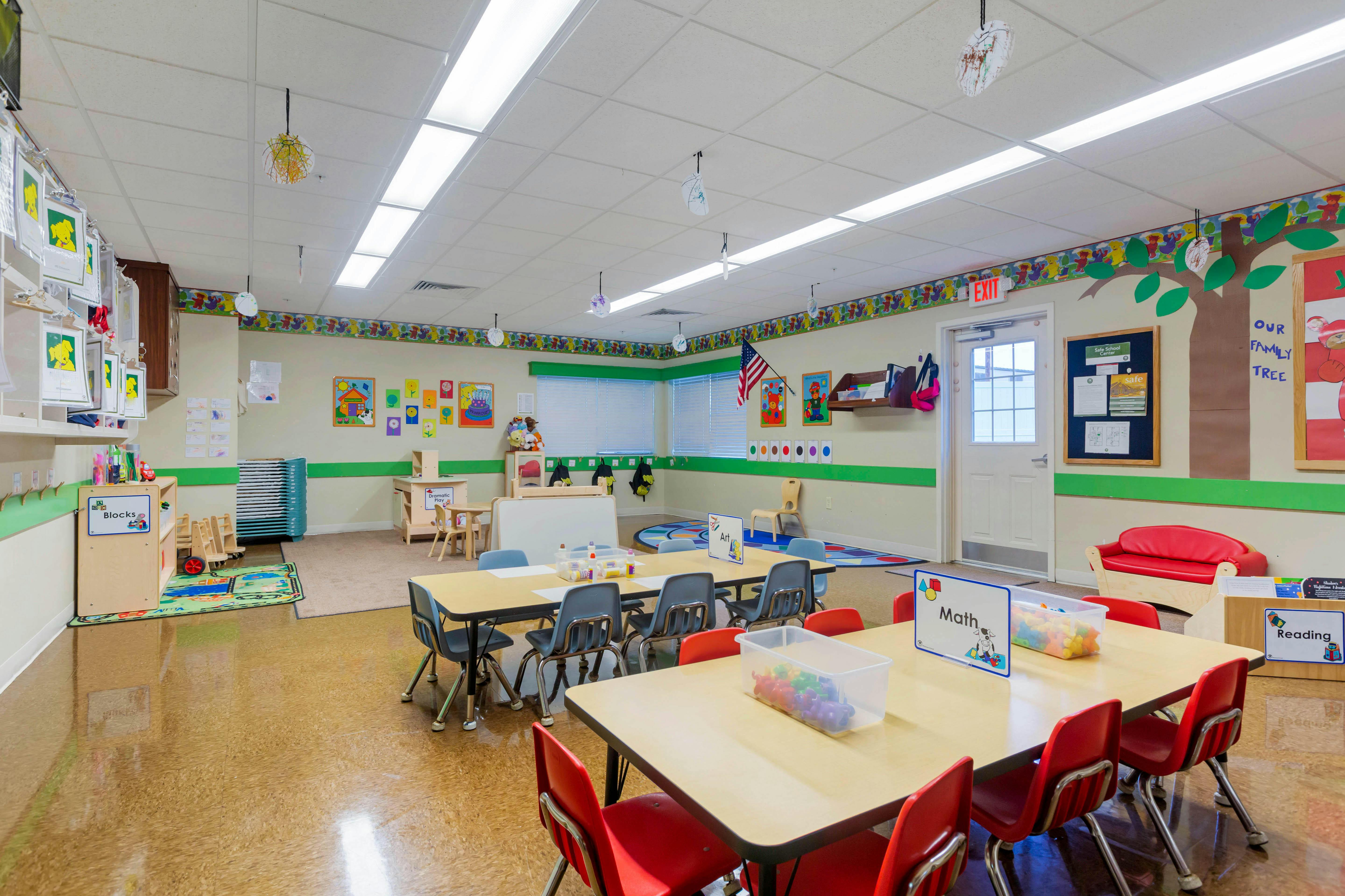 Empty classroom with small tables and chairs
