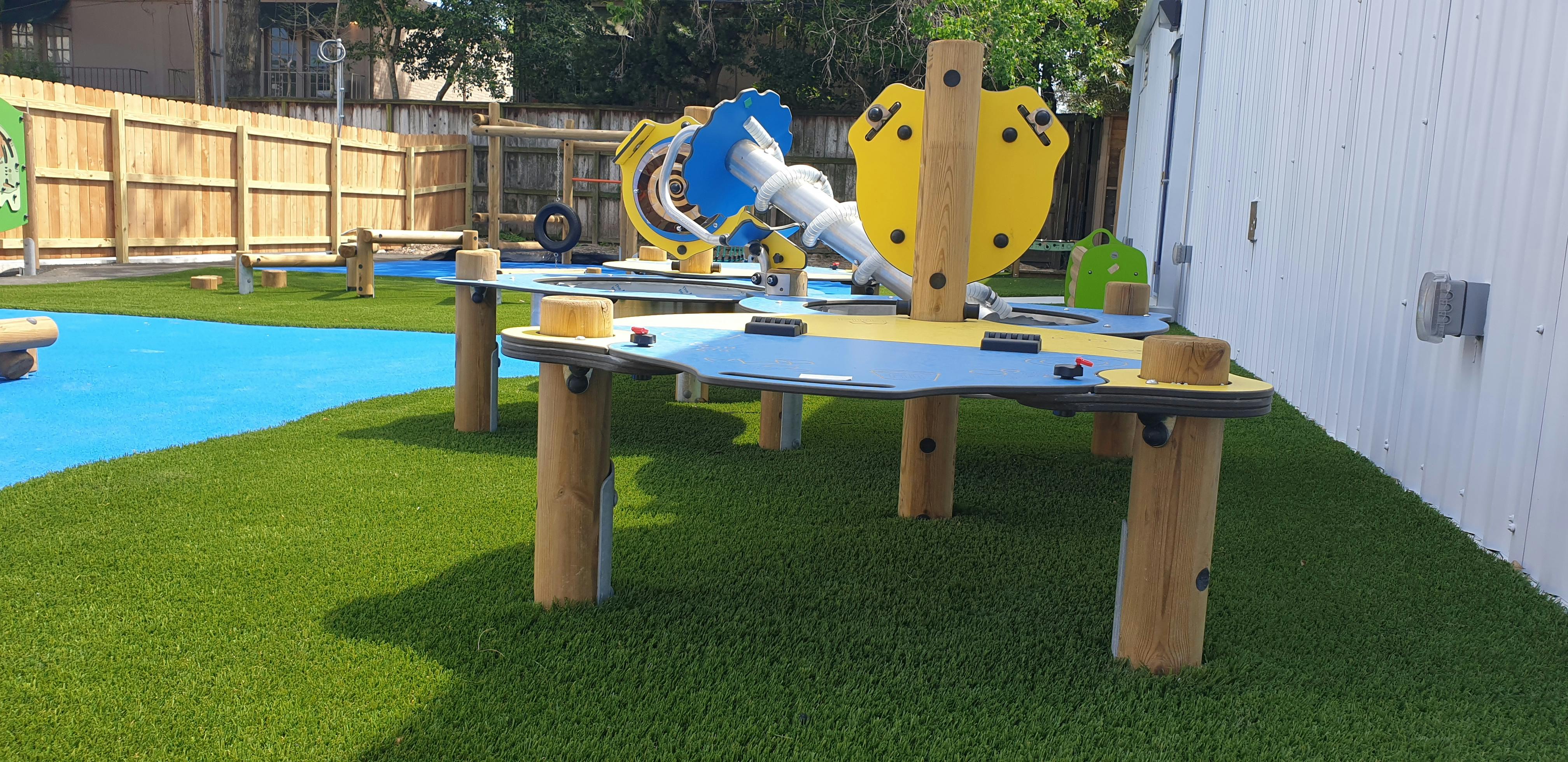 Playground with artificial turf and blue soft flooring