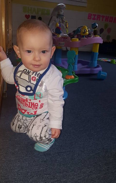Child kneeling on a carpeted floor