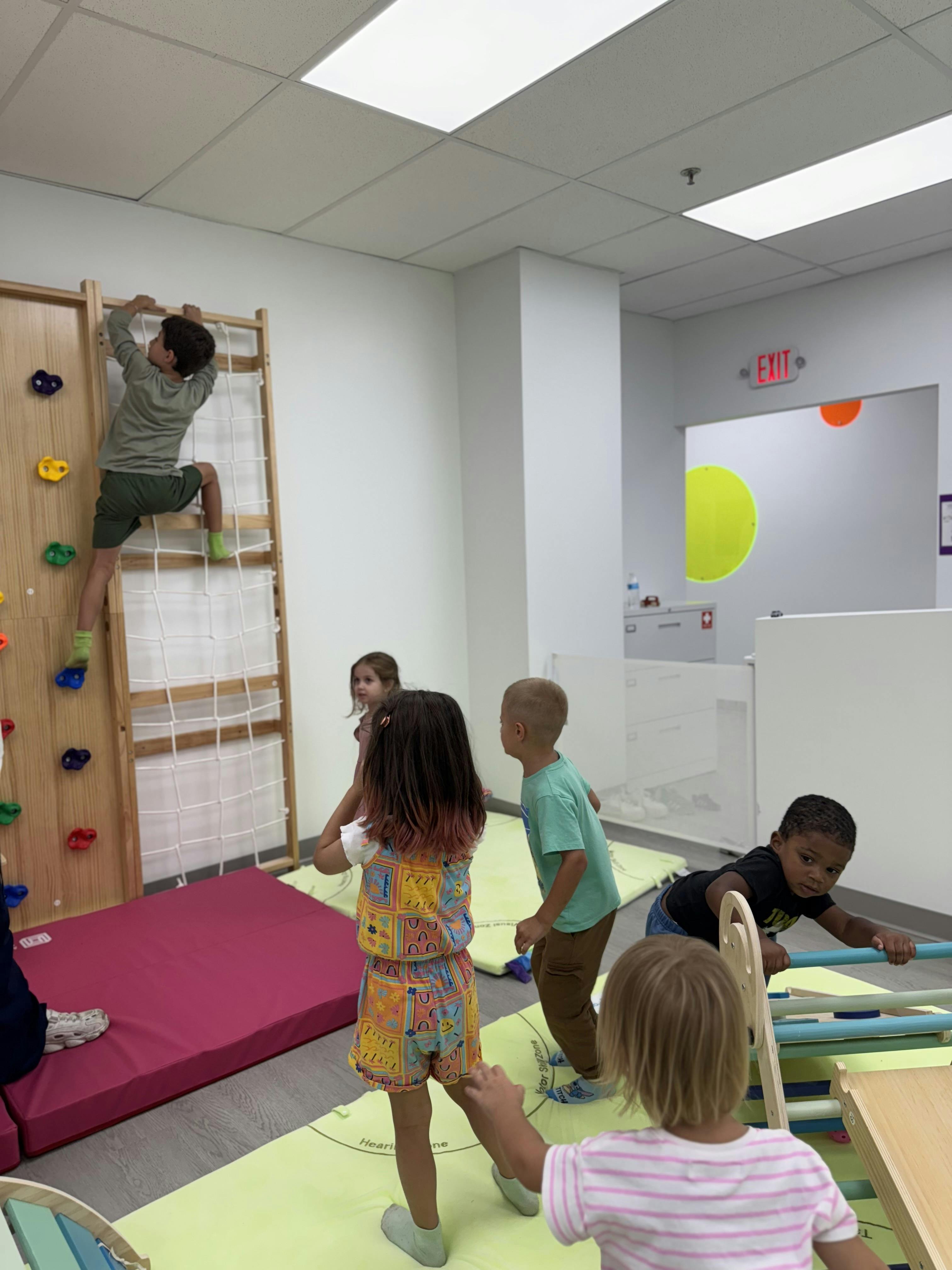 Children playing on climbing structures in a room