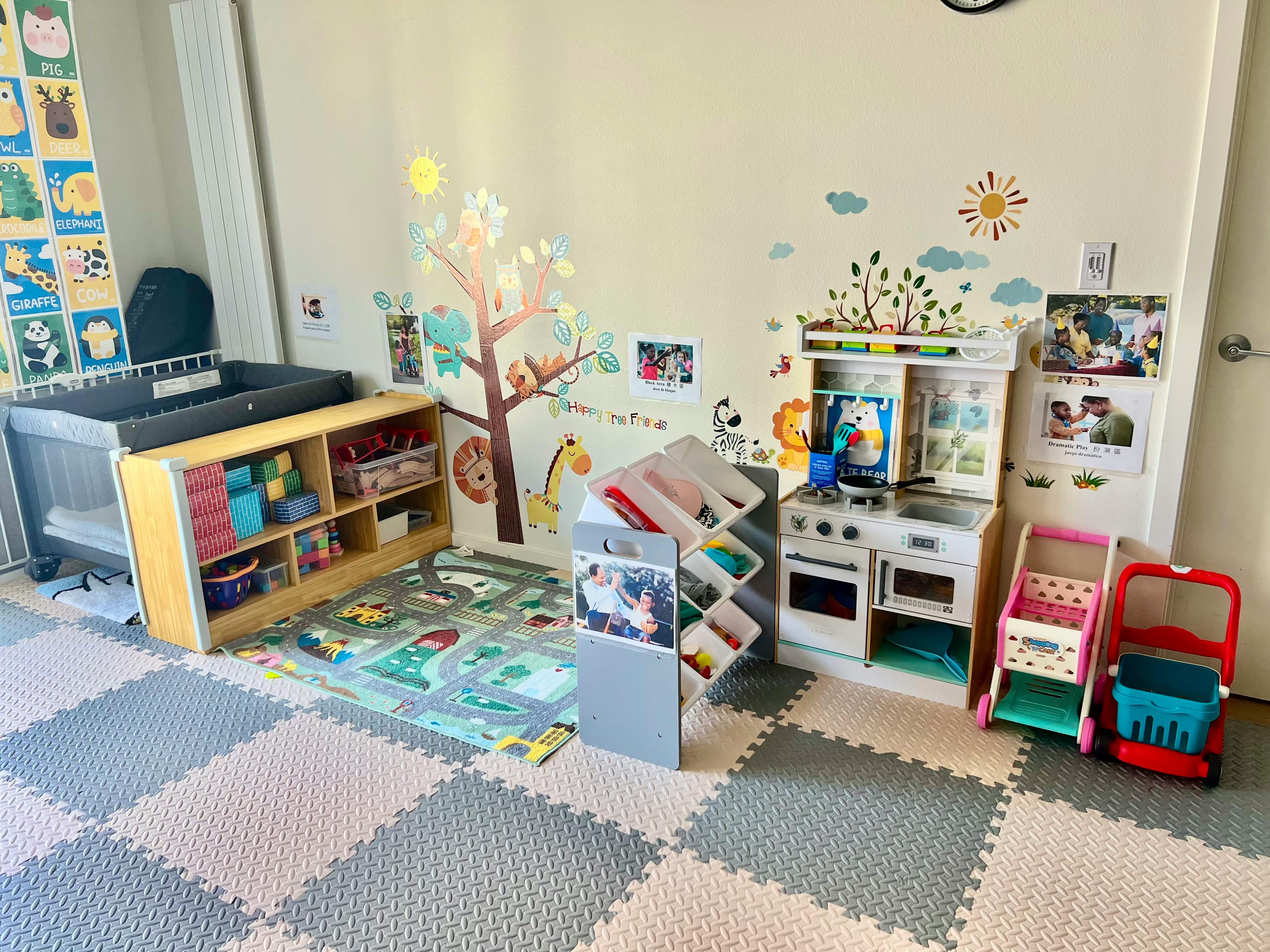 Playroom with changing table, toy shelf, play kitchen, and toy carts