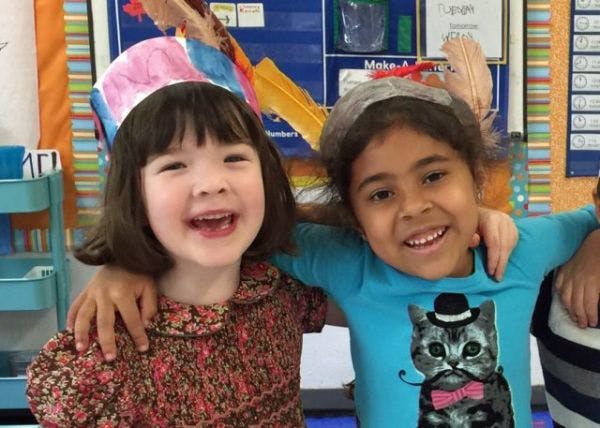 Two children with arms around each other