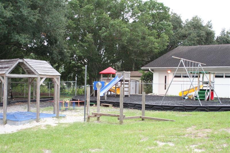 Outdoor playground with slides, swings, and a sandbox