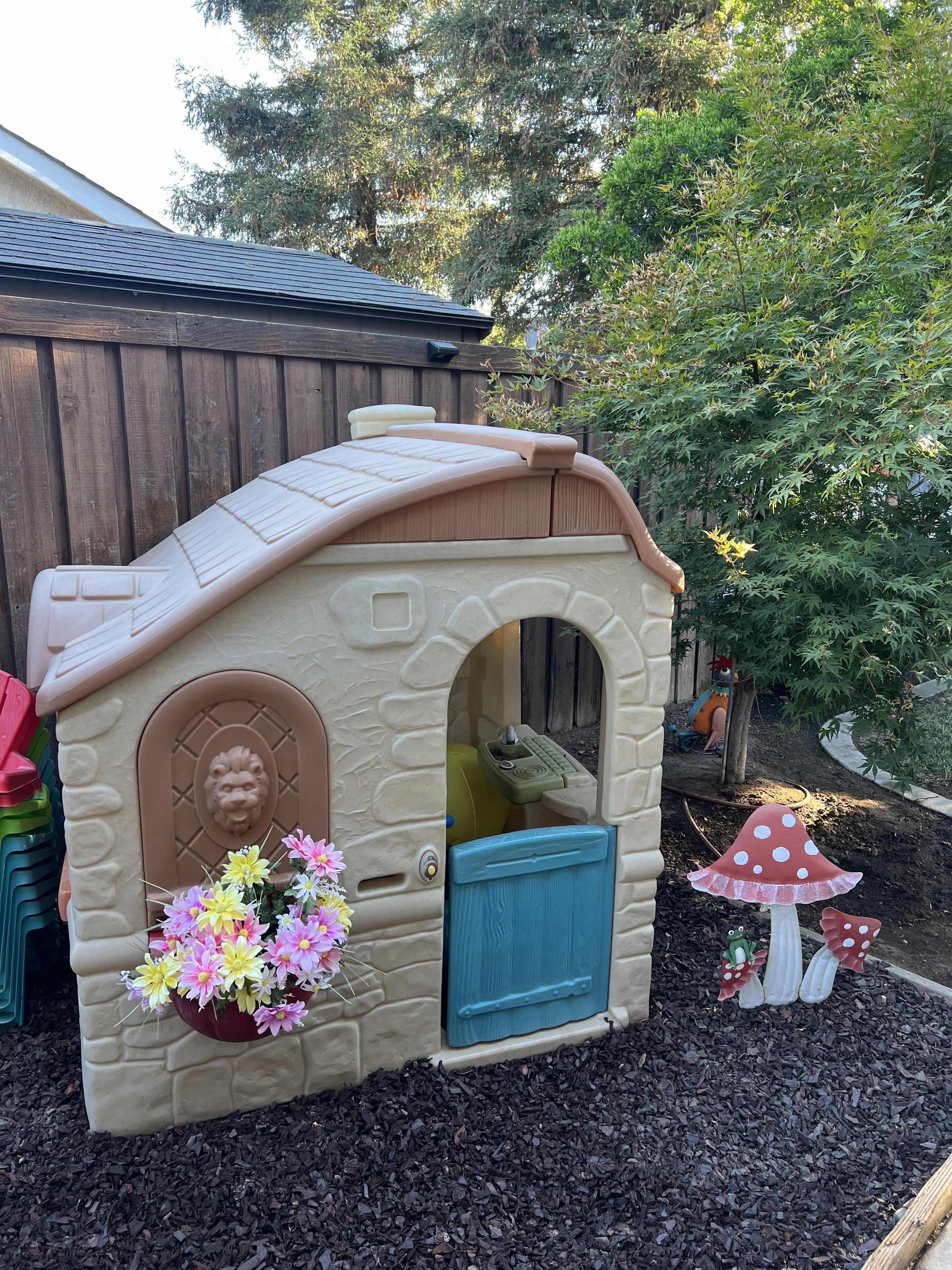 Child's playhouse with flowers and mushroom decorations