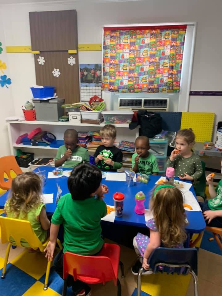 Children sitting at a table in a classroom