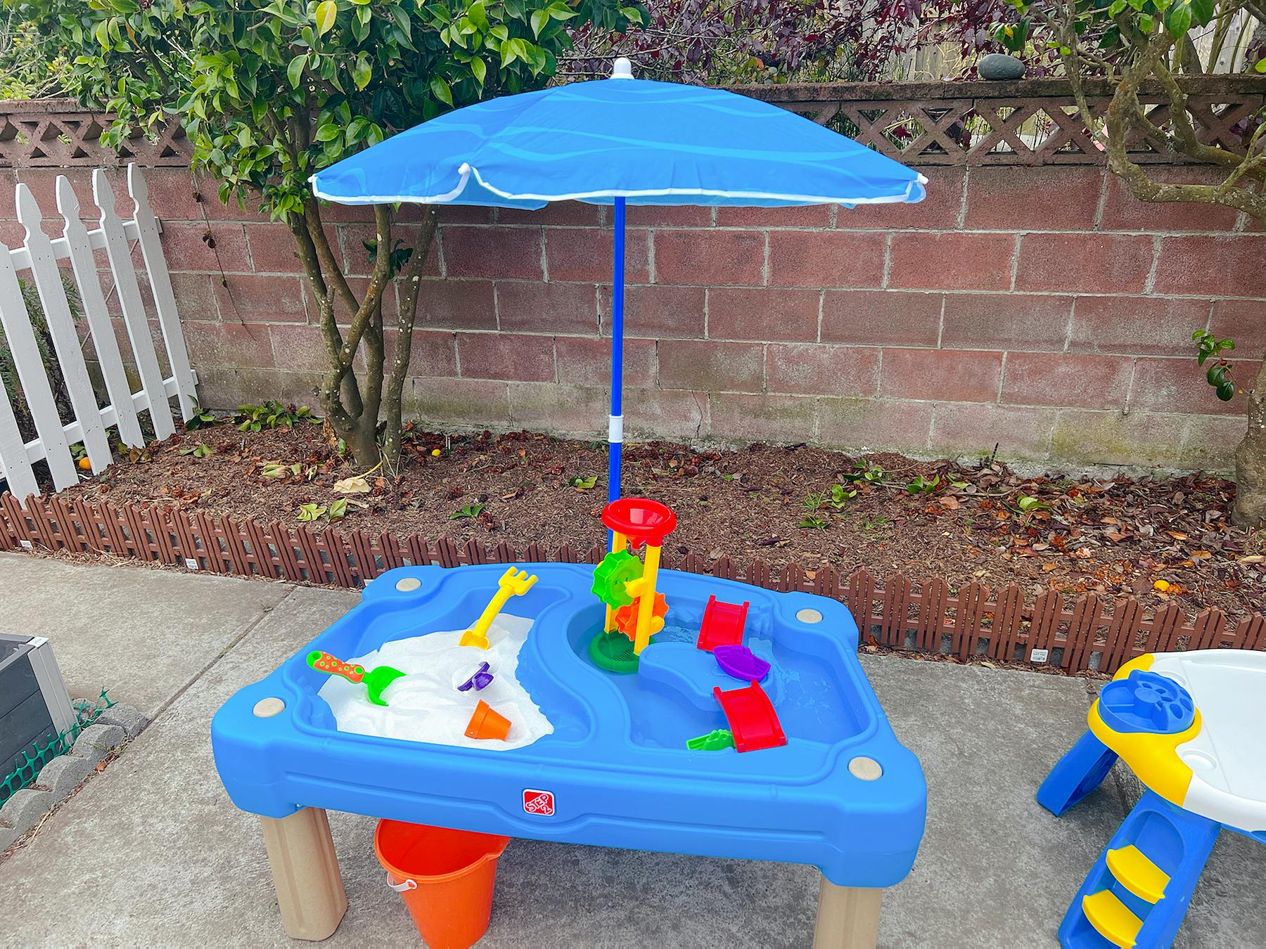 Blue sand and water table with a blue umbrella