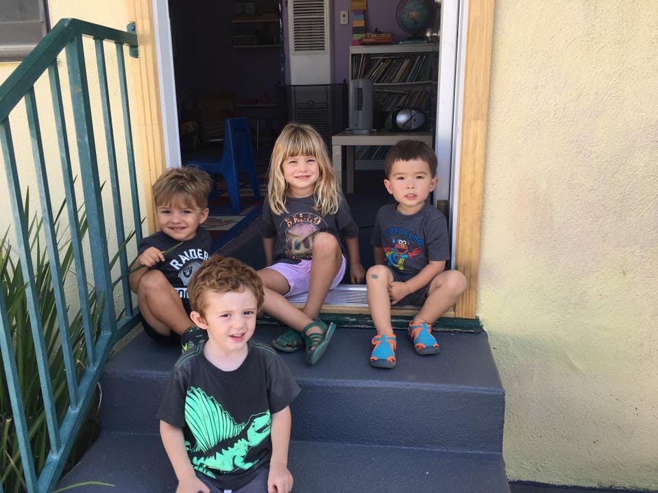 Four children sitting on steps