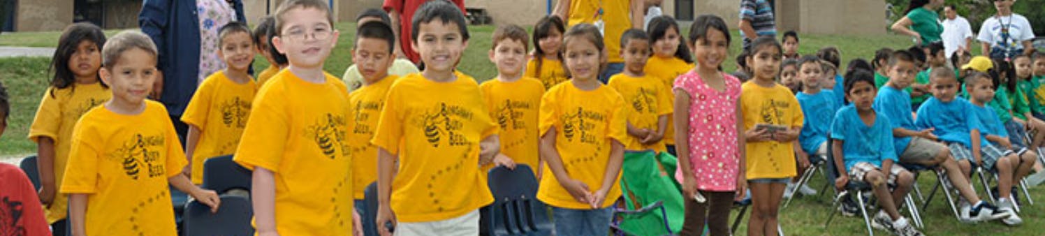Group of children standing and sitting outdoors