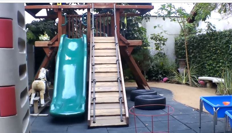 Playground with slide, stairs, and tires