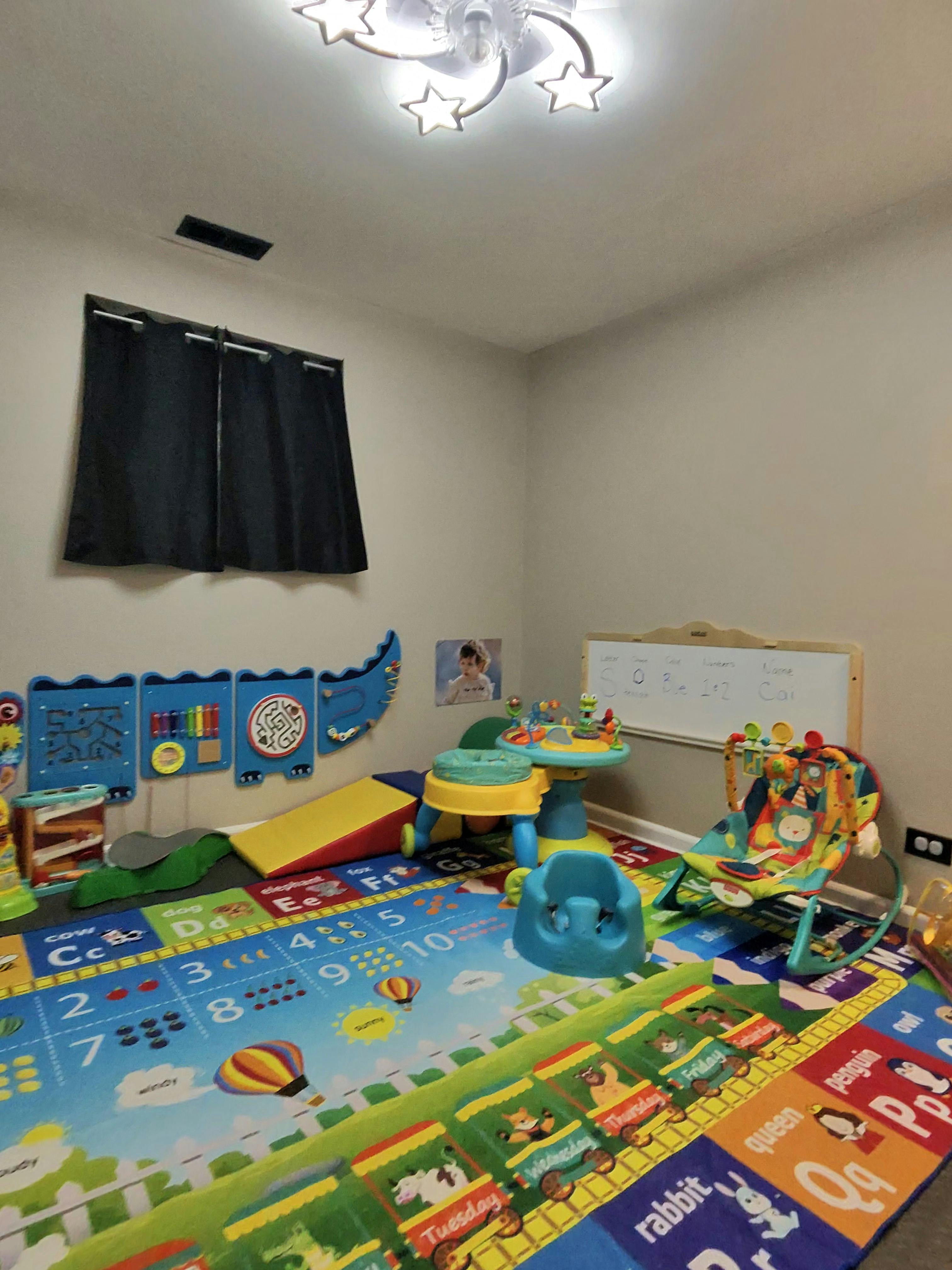 Colorful child play area with educational floor mats and activity stations