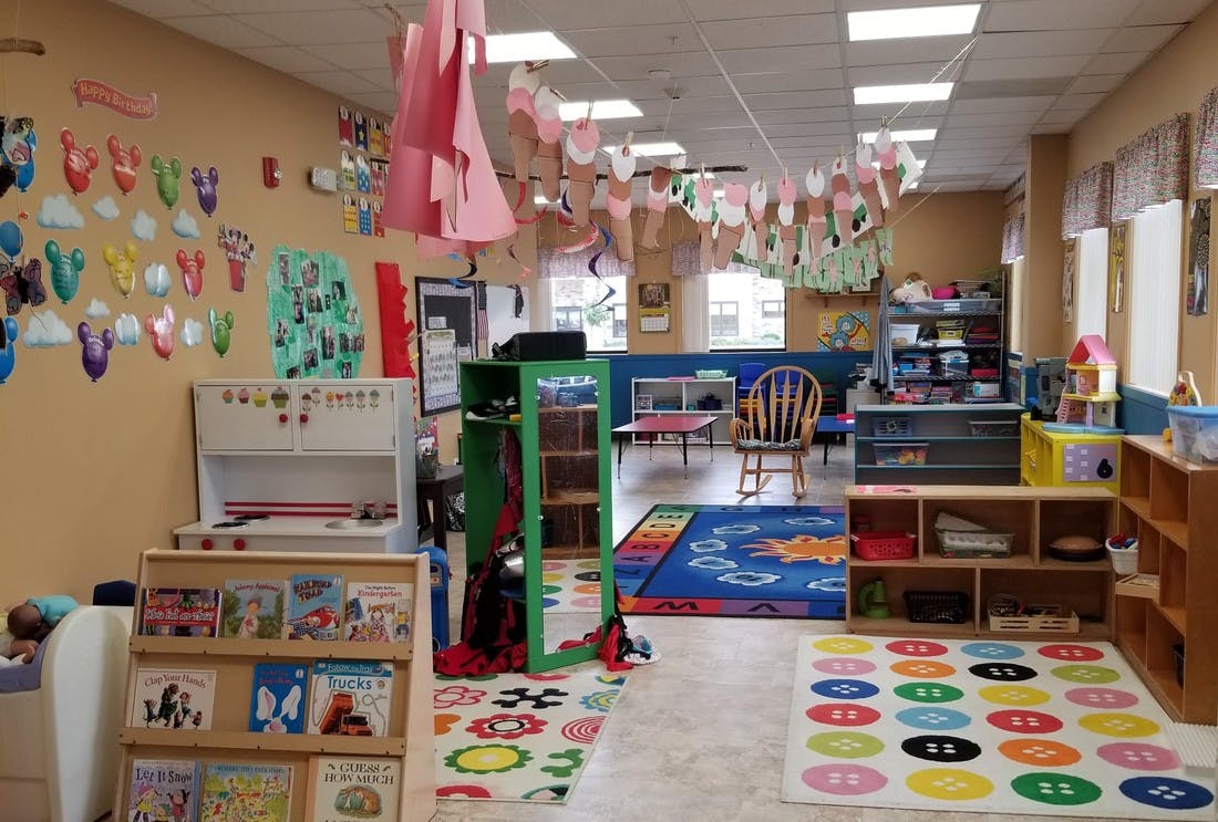 Colorful classroom with rugs, shelves, and decorations