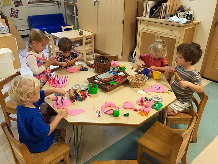 Children playing with modeling clay at a table