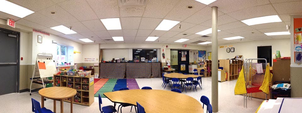 Empty classroom with small tables and chairs