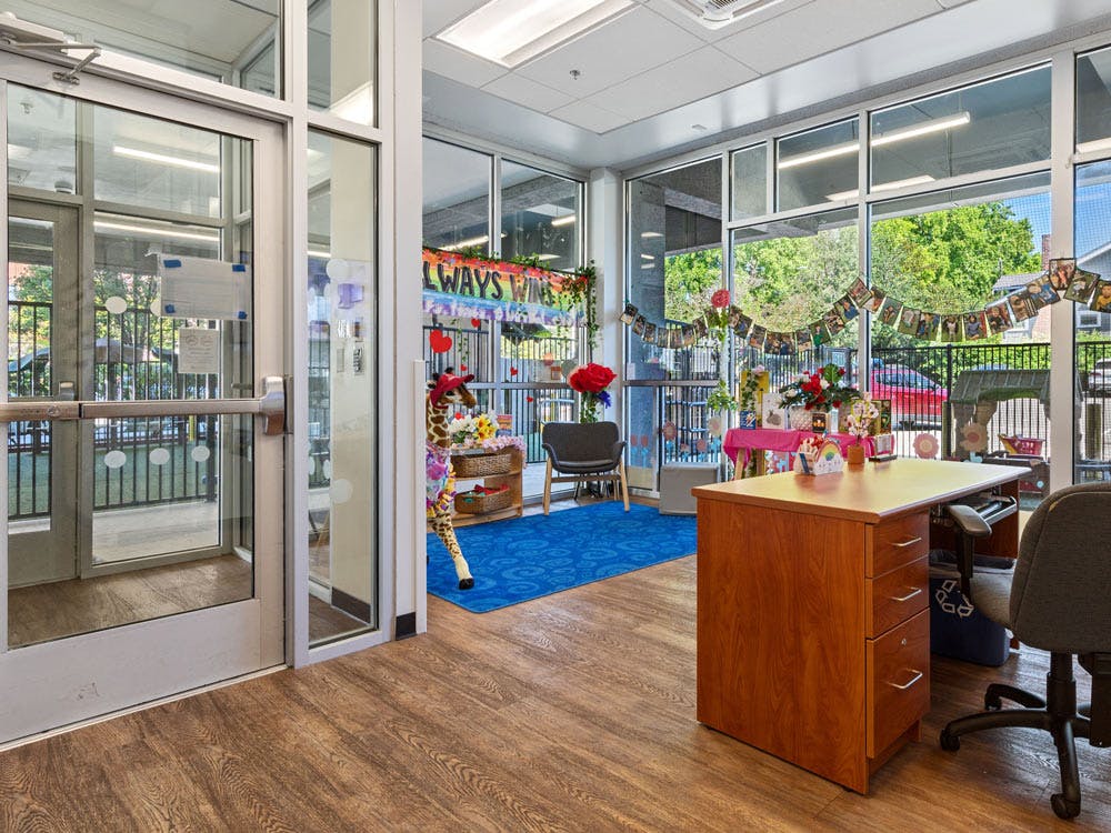 An office area with a wooden desk and chair, decorated for a celebration