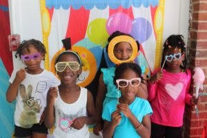 Five children wearing novelty glasses and headbands