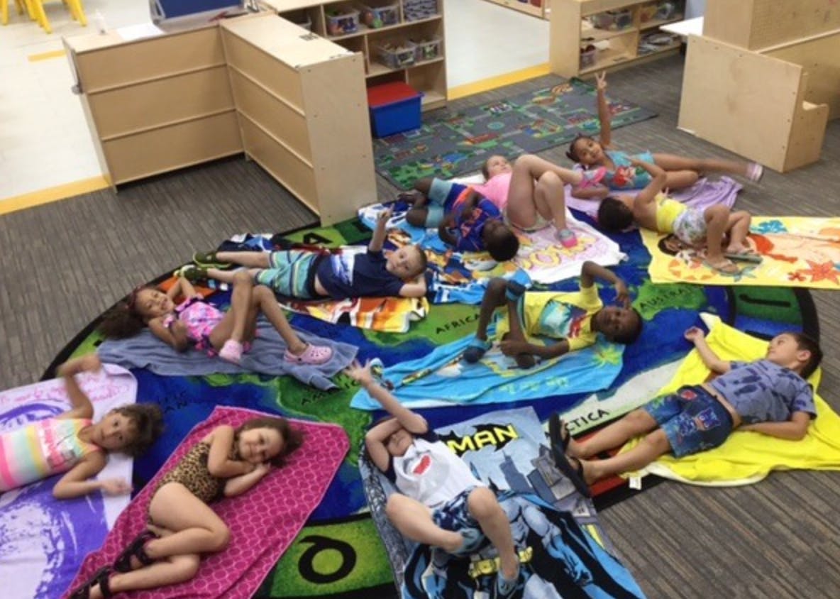 Children lying on blankets on the floor