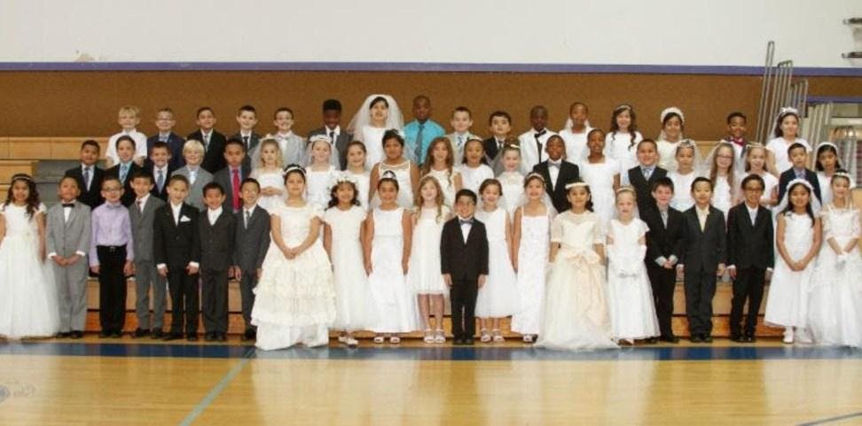 Large group of children and adults posing for a photo