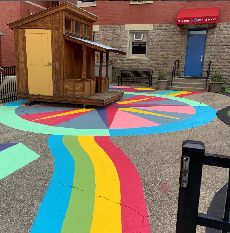 Wooden playhouse on colorful painted ground