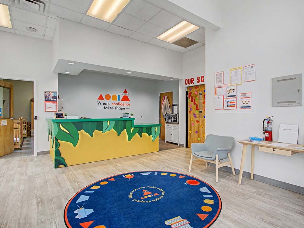 Reception area in a children's learning center with a decorated desk