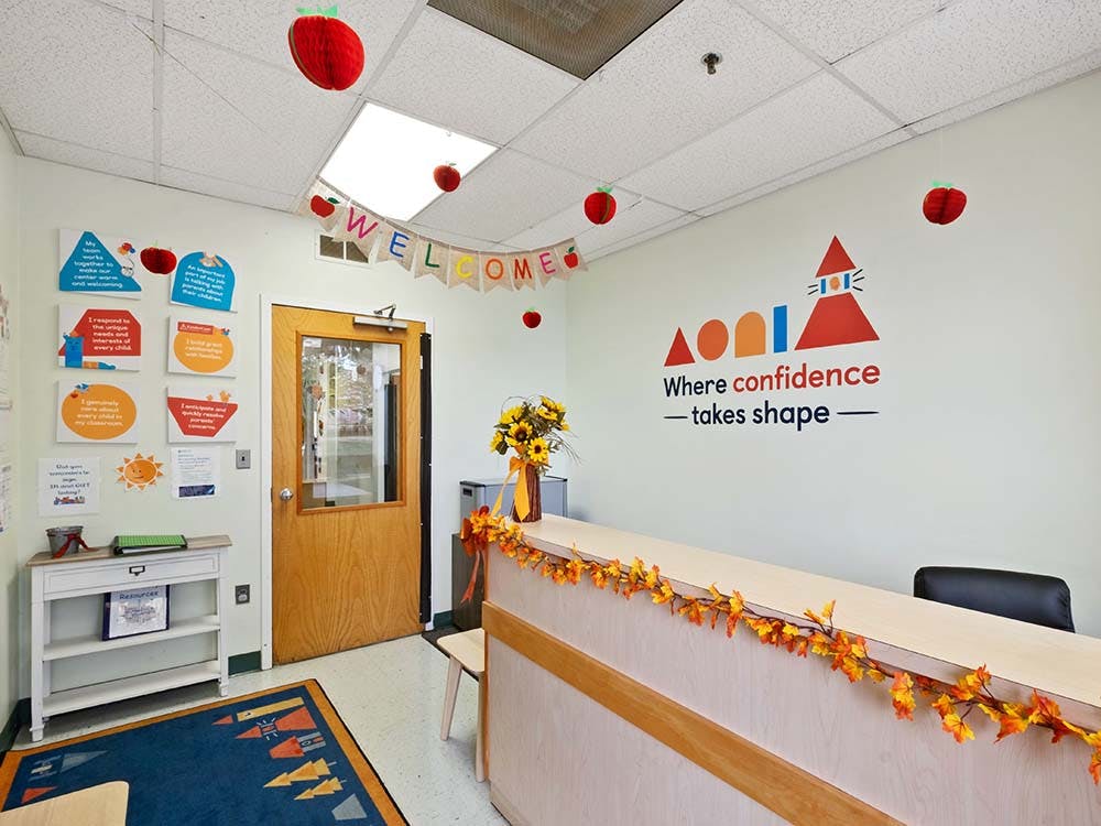 Reception area with a "Welcome" banner and fall decorations